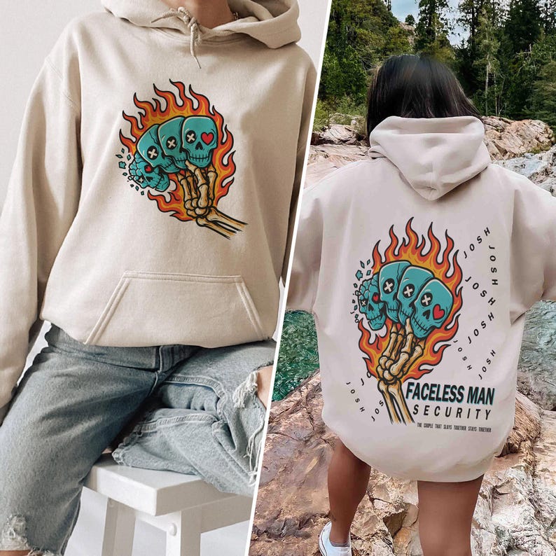 Puede incluir: Sudadera con capucha beige con un bolsillo delantero y un gr&aacute;fico de tres calaveras azules con corazones y cruces, rodeadas de llamas naranjas, sostenidas por una mano esquel&eacute;tica. La parte trasera tiene el mismo gr&aacute;fico y el texto "FACELSS MAN SECURITY".
