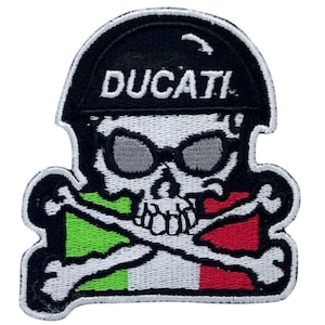 May include: Embroidered patch featuring a skull wearing sunglasses and a black helmet with the word "DUCATI" in white. The skull has crossbones and an Italian flag design in green, white, and red.