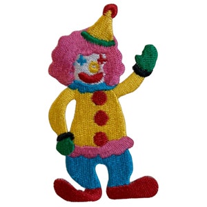 May include: An embroidered iron-on patch depicting a clown with a pink wig, yellow shirt, blue trousers, and red shoes. The clown is waving with one hand and has a big smile on its face.