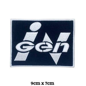May include: White embroidered patch with the word "iGen" in a stylised font on a dark blue background. The patch measures 9 cm by 7 cm.