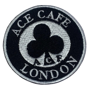 May include: Black and white embroidered patch with the text "ACE CAFE LONDON" and a black clover in the center.