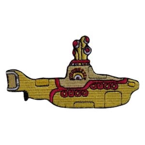 May include: Yellow submarine with red and white details, a popular image associated with the Beatles.