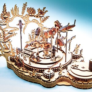 May include: A wooden laser-cut carousel featuring an underwater theme. The carousel has various sea creatures, including fish and turtles, and is decorated with coral and seaweed. The carousel is made of light brown wood and has intricate details.