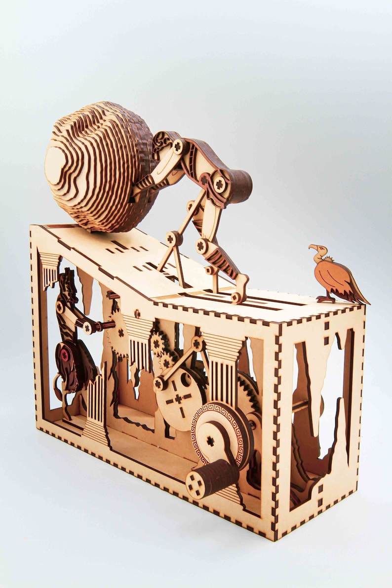 May include: A wooden model of a complex machine with gears and a figure pushing a large ball up a ramp. The machine is made of light brown wood with dark brown accents. A bird is perched on the top of the machine.