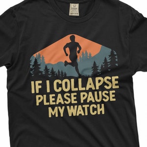May include: Black t-shirt with a silhouette of a runner in front of a sunset mountain scene. The text "IF I COLLAPSE PLEASE PAUSE MY WATCH" is printed in yellow.
