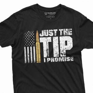 May include: Black t-shirt with a distressed white graphic of an American flag, a bullet, and the text "Just the Tip I Promise".