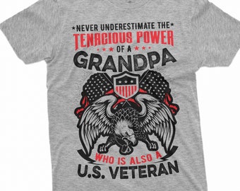 May include: Grey t-shirt with a red and black graphic design featuring an eagle with wings spread, a shield with stars, and the text "Never underestimate the tenacious power of a Grandpa who is also a U.S. Veteran."