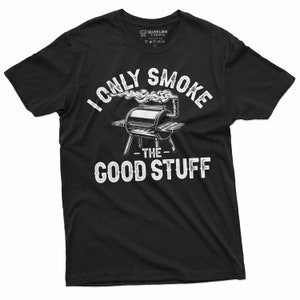 May include: Black t-shirt with a white graphic of a grill with smoke coming out of it. The text "I only smoke the good stuff" is printed on the shirt.