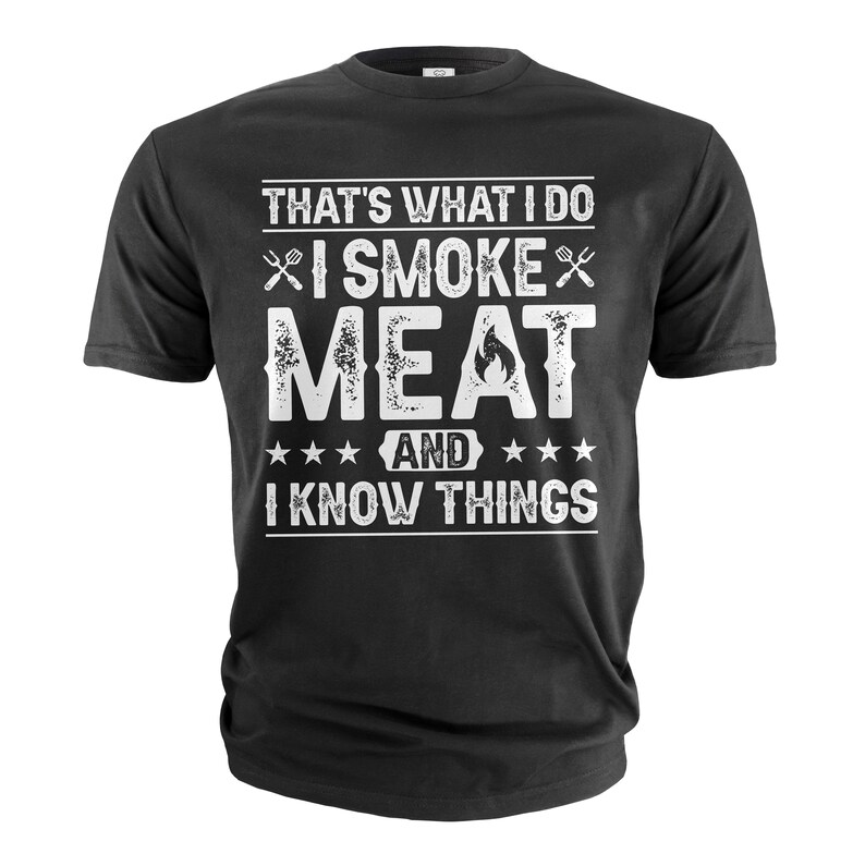 May include: Black t-shirt with white text that reads "That's what I do I smoke meat and I know things". The text is distressed and includes a flame graphic.
