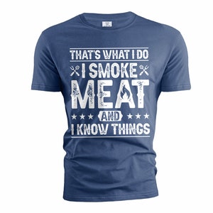 May include: A blue t-shirt with a white distressed graphic that reads "That's what I do I smoke meat and I know things".