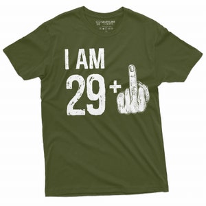 May include: A green t-shirt with white text that says "I AM 29+" with a white middle finger graphic.