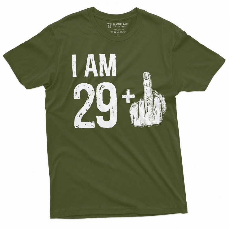 May include: A green t-shirt with white text that says "I AM 29+" with a white middle finger graphic.