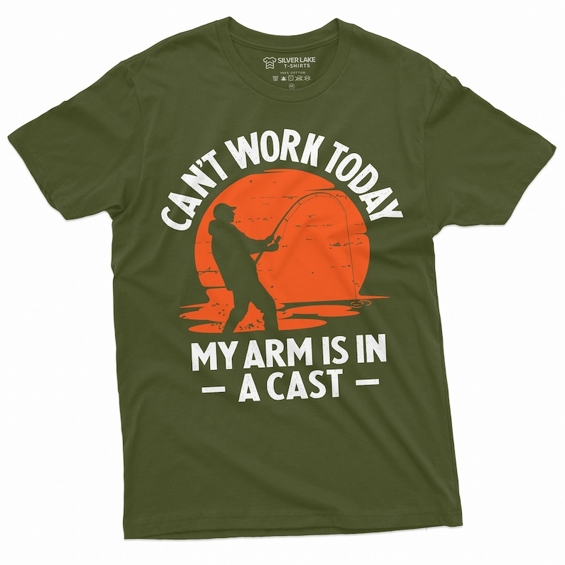 May include: A green t-shirt with a white graphic of a person fishing with the text "Can't work today my arm is in a cast" printed on it.