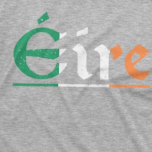May include: A gray t-shirt with the word "&Eacute;ire" printed in white with green and orange accents. The word is in a distressed font style.