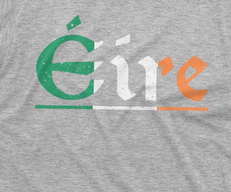 May include: A gray t-shirt with the word "&Eacute;ire" printed in white with green and orange accents. The word is in a distressed font style.
