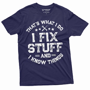 May include: Navy blue t-shirt with a white distressed graphic that says "That's what I do I fix stuff and I know things". The graphic also includes a wrench and three stars.
