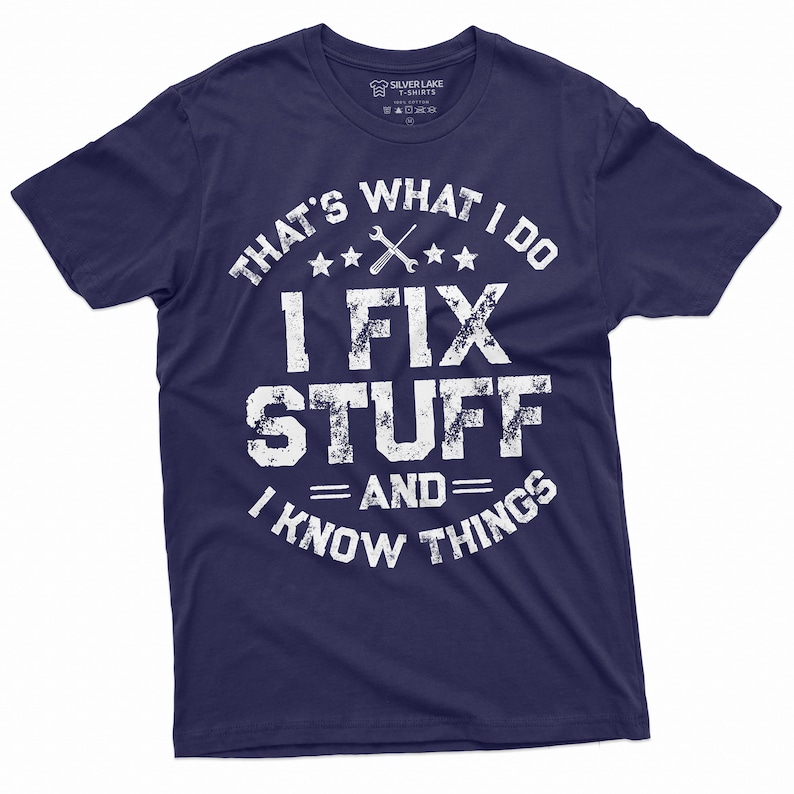 May include: Navy blue t-shirt with a white distressed graphic that says "That's what I do I fix stuff and I know things". The graphic also includes a wrench and three stars.