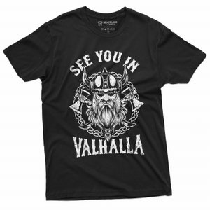 May include: Black t-shirt with a white graphic of a Viking warrior wearing a horned helmet, with the text "SEE YOU IN VALHALLA". The design includes crossed axes and a chain border. The shirt is from Silver Lake T-Shirts.