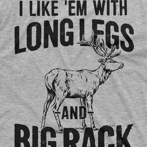 May include: A gray t-shirt with a black graphic print of a deer with large antlers and the text "I like 'em with long legs and big rack".