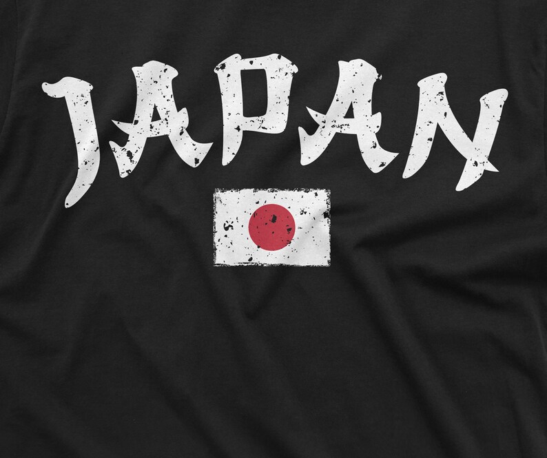 May include: Black t-shirt with white distressed lettering that says "JAPAN" and a white distressed image of the Japanese flag with a red circle in the center.