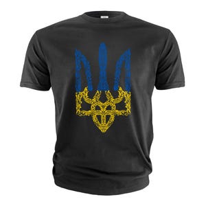 May include: Black t-shirt with a yellow and blue stylized floral design of the Ukrainian trident.