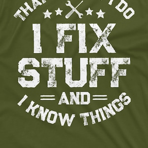 May include: A green t-shirt with a white distressed graphic that says "That's what I do I fix stuff and I know things". The graphic also includes a wrench and screwdriver crossed over each other and four stars.