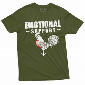 May include: A green t-shirt with a white rooster graphic and the text "Emotional Support" printed on the front.
