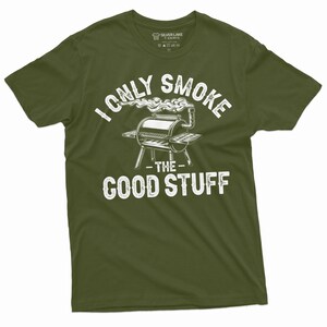 May include: A green t-shirt with a white graphic of a grill with smoke coming out of it. The text on the shirt reads "I only smoke the good stuff".