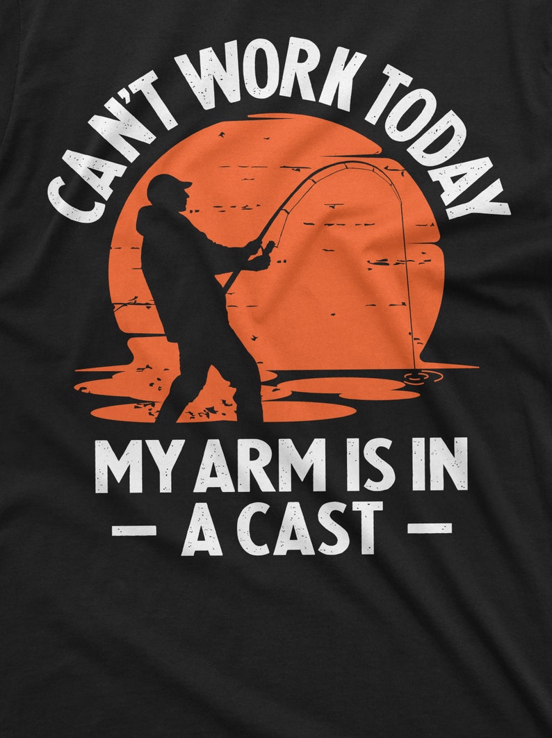 May include: A black t-shirt with a white graphic of a silhouette of a person fishing with the text "Can't work today - My arm is in a cast -"