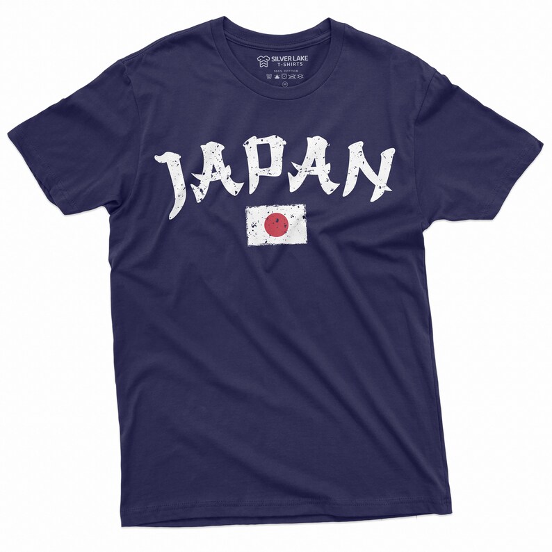 May include: A navy blue t-shirt with a white distressed graphic of the word "JAPAN" and the Japanese flag.