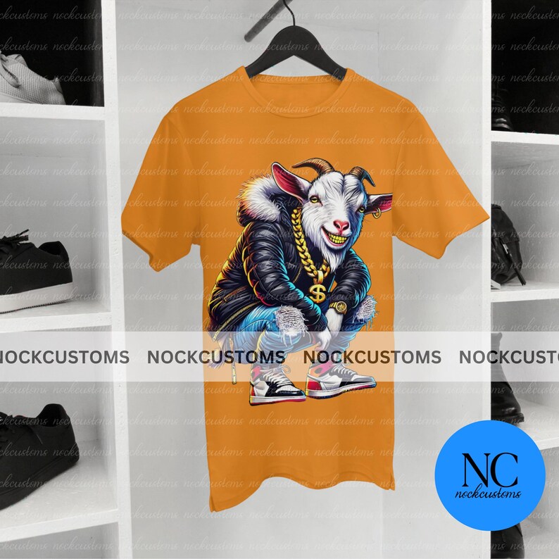 May include: A yellow t-shirt with a cartoon image of a goat wearing a black jacket, blue jeans, and a gold chain. The goat is sitting with its legs crossed and has a dollar sign on its chest. The goat is wearing a pair of red and blue sneakers.