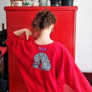 Hand embroidered thai tiger on red oversized blouse