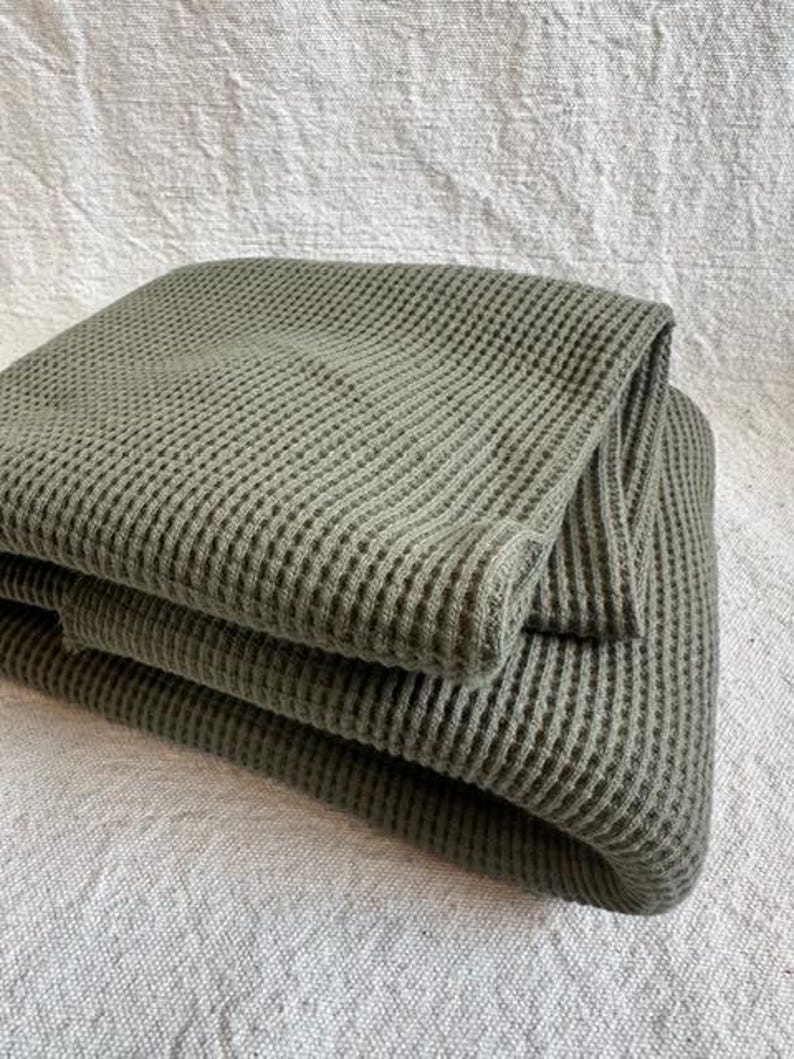 Premium cotton waffle knit fabric displayed flat to highlight its textured waffle pattern and heavyweight quality. This versatile thermal knit fabric is ideal for sewing comfortable apparel such as hoodies, joggers, sweaters, and cozy loungewear, as well as home items like blankets and throws. Made from cotton, it offers softness, durability, and breathability. Fabric is sold by the half yard and works well for year-round sewing projects.