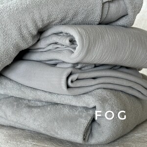 "Rolled organic cotton sponge knit terry fabric, showcasing its soft, breathable texture. Perfect for sewing baby apparel, loungewear, and handmade garments with a cozy touch. The American-milled fabric offers premium quality and durability, ensuring long-lasting wear and comfort."