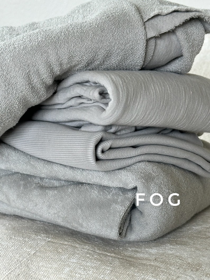"Rolled organic cotton sponge knit terry fabric, showcasing its soft, breathable texture. Perfect for sewing baby apparel, loungewear, and handmade garments with a cozy touch. The American-milled fabric offers premium quality and durability, ensuring long-lasting wear and comfort."