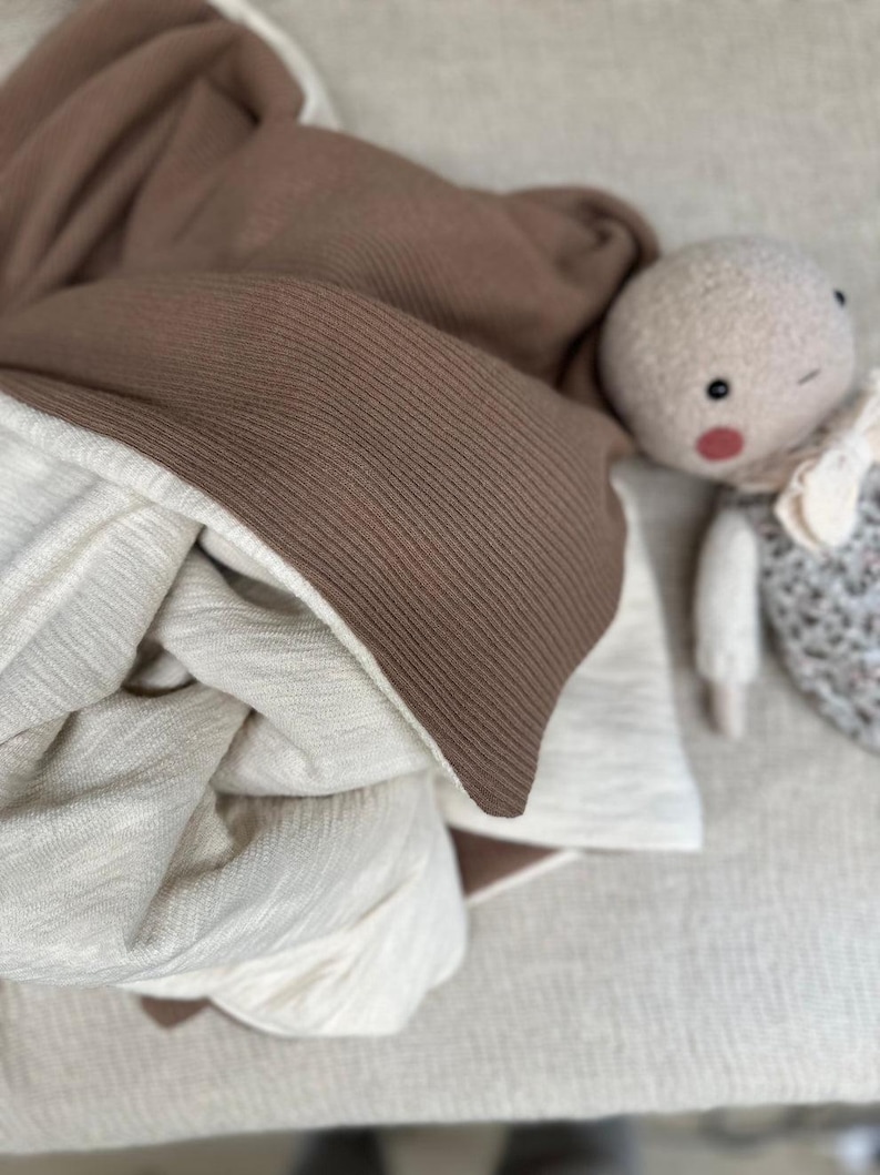 Folded heavy cotton rib knit fabric stacked in layers to illustrate softness, density, and texture. Perfect for cozy winter apparel and sewing projects, this image emphasizes the fabric’s weight, structure, and adaptability for crafting personalized wardrobe essentials.