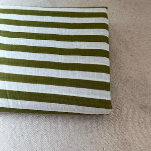 "Folded Carnival Cotton fabric, emphasizing its crisp texture and timeless appeal. Perfect for creating tailored dresses, structured skirts, and stylish tops. The artisan prints offer durability while maintaining a soft, comfortable touch."