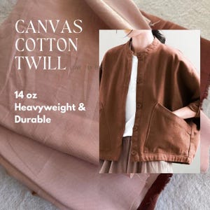 May include: A brown canvas cotton twill fabric with the text "CANVAS COTTON TWILL 14 oz Heavyweight & Durable". The fabric is shown folded and a brown jacket made from the same fabric is shown in the background.