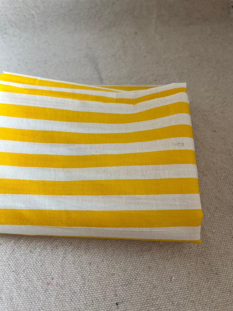 "Close-up of Carnival Cotton fabric, emphasizing its unique weave and airy structure. Great for crafting baby rompers, sleepwear, and casual apparel. The breathable cotton enhances airflow, ensuring a cozy and stylish touch for handmade garments."