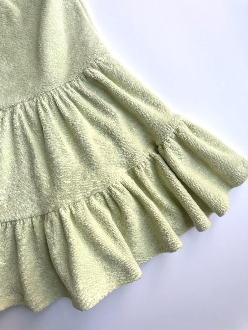 "Close-up of organic cotton sponge knit terry fabric, highlighting its soft, absorbent loops and breathable texture. Ideal for sewing sweatshirts, baby clothes, and cozy loungewear. The eco-friendly cotton ensures comfort and durability, making it perfect for handmade apparel and sustainable fashion."