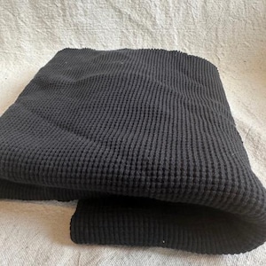 Thick cotton waffle knit fabric with a textured thermal weave designed for warm and cozy sewing projects. This premium heavy waffle fabric is suitable for hoodies, sweaters, lounge sets, baby items, and blankets. The natural cotton fiber offers breathability and softness, while the waffle texture provides insulation and visual interest. Sold by the half yard, this fabric is easy to work with and perfect for both beginner and experienced sewists.