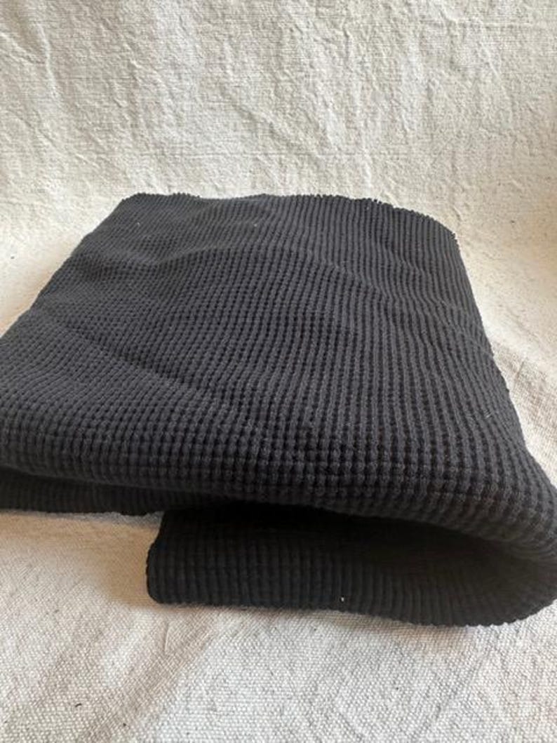 Thick cotton waffle knit fabric with a textured thermal weave designed for warm and cozy sewing projects. This premium heavy waffle fabric is suitable for hoodies, sweaters, lounge sets, baby items, and blankets. The natural cotton fiber offers breathability and softness, while the waffle texture provides insulation and visual interest. Sold by the half yard, this fabric is easy to work with and perfect for both beginner and experienced sewists.