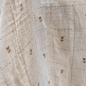 Salt Air cotton gauze fabric styled in loose folds to showcase its soft hand and breathable structure. This lightweight double gauze features a subtle crinkle texture and fluid drape, perfect for creating comfortable, easy-to-wear garments. Ideal for summer sewing, baby blankets, and layering pieces, this cotton fabric offers a natural, organic look with a timeless aesthetic. Its soft finish makes it suitable for sensitive skin and everyday use.