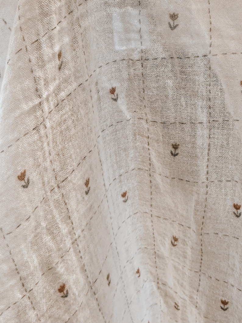 Salt Air cotton gauze fabric styled in loose folds to showcase its soft hand and breathable structure. This lightweight double gauze features a subtle crinkle texture and fluid drape, perfect for creating comfortable, easy-to-wear garments. Ideal for summer sewing, baby blankets, and layering pieces, this cotton fabric offers a natural, organic look with a timeless aesthetic. Its soft finish makes it suitable for sensitive skin and everyday use.