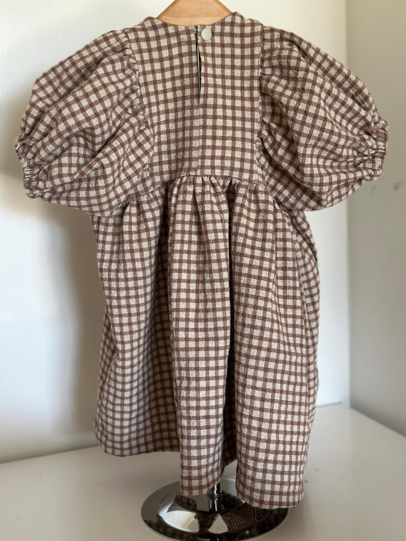 "Rolled gingham linen-cotton blend fabric, emphasizing its lightweight, eco-friendly composition. Perfect for sewing summer outfits, aprons, and upholstery projects. The breathable weave enhances airflow, ensuring a cool and comfortable feel for everyday wear."