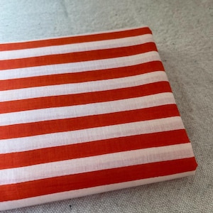"Rolled Carnival Cotton fabric, showcasing its eco-friendly composition and smooth weave. Ideal for sewing elegant apparel, lightweight scarves, and decorative home textiles. The breathable fabric enhances airflow, ensuring a cool and comfortable feel."