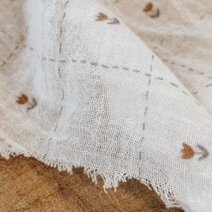 Airy Salt Air cotton gauze fabric presented with gentle folds to highlight its lightweight feel and soft texture. This double gauze cotton fabric features a breathable weave and slightly crinkled surface, perfect for relaxed garments and baby-friendly projects. Ideal for dresses, tops, swaddles, and scarves, this fabric combines comfort with a natural, coastal-inspired look. Its soft drape and neutral tone make it a versatile choice for modern sewing designs.