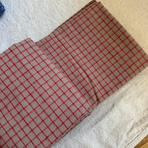 Image of a handmade tote bag crafted from brushed cotton grid plaid fabric. Highlights the fabric's durability and stylish pattern for accessories. The soft brushed texture enhances comfort, while the plaid grid pattern lends timeless appeal. A perfect DIY project base for gifts, retail items, and personal fashion statements.