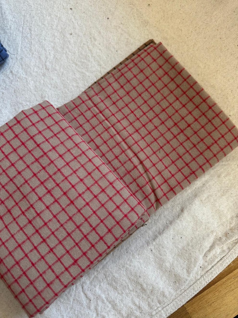 Image of a handmade tote bag crafted from brushed cotton grid plaid fabric. Highlights the fabric's durability and stylish pattern for accessories. The soft brushed texture enhances comfort, while the plaid grid pattern lends timeless appeal. A perfect DIY project base for gifts, retail items, and personal fashion statements.