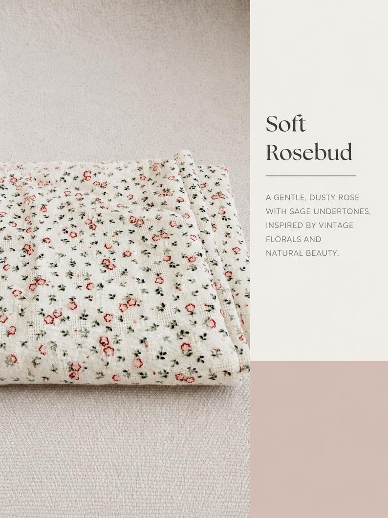 May include: A folded white fabric featuring a repeating pattern of small red rosebuds and green leaves. The text on the right side reads: Soft Rosebud. A GENTLE, DUSTY ROSE WITH SAGE UNDERTONES, INSPIRED BY VINTAGE FLORALS AND NATURAL BEAUTY.